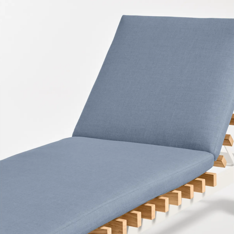 The Perch Outdoor Sun Lounger from Blu Dot with the white frame and sunbrella haze upholstery close up.