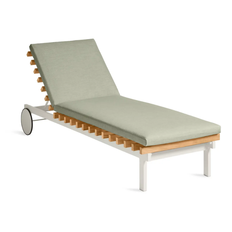The Perch Outdoor Sun Lounger from Blu Dot with the white frame and sunbrella oasis upholstery from an angle.