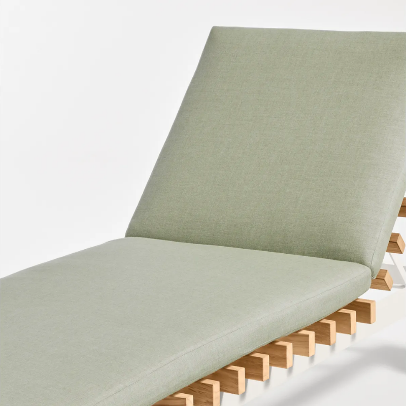 The Perch Outdoor Sun Lounger from Blu Dot with the white frame and sunbrella oasis upholstery close up.