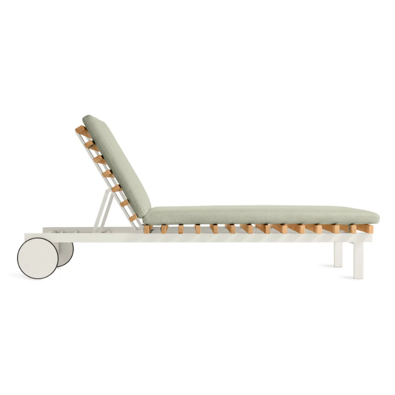 The Perch Outdoor Sun Lounger from Blu Dot with the white frame and sunbrella oasis upholstery from the side.
