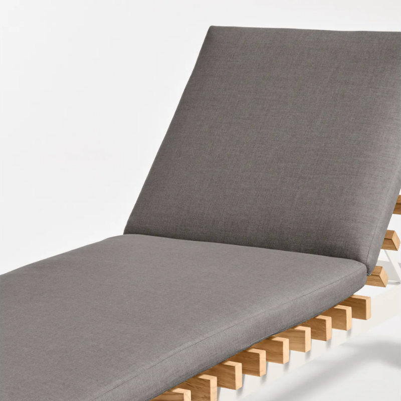 The Perch Outdoor Sun Lounger from Blu Dot with the white frame and toohey charcoal upholstery close up.