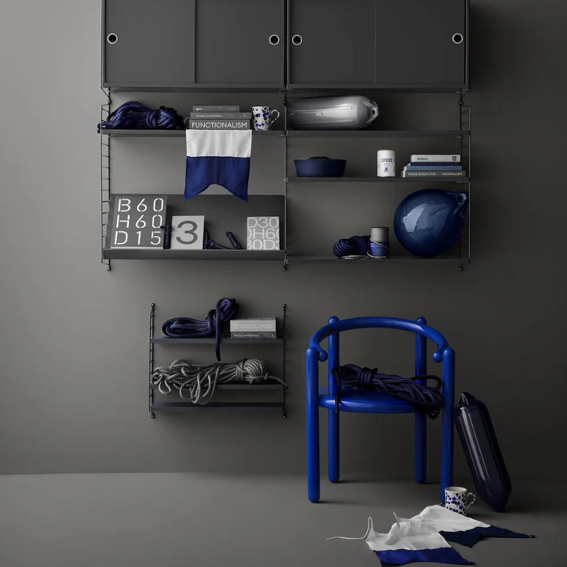 The String Pocket from String Furniture in nybobia in a guest room.