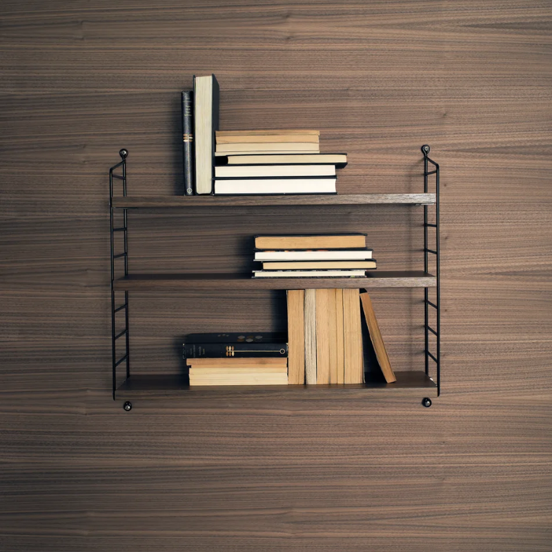 The String Pocket from String Furniture in walnut and black in a home office.