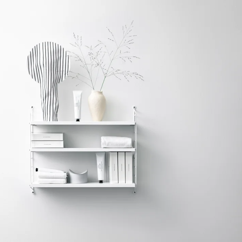 The String Pocket from String Furniture in white in a living room.