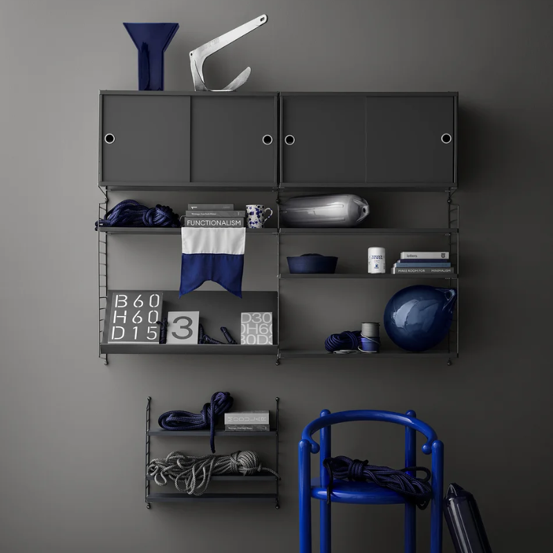 The dark grey Wall Panels from String Furniture in a living room.