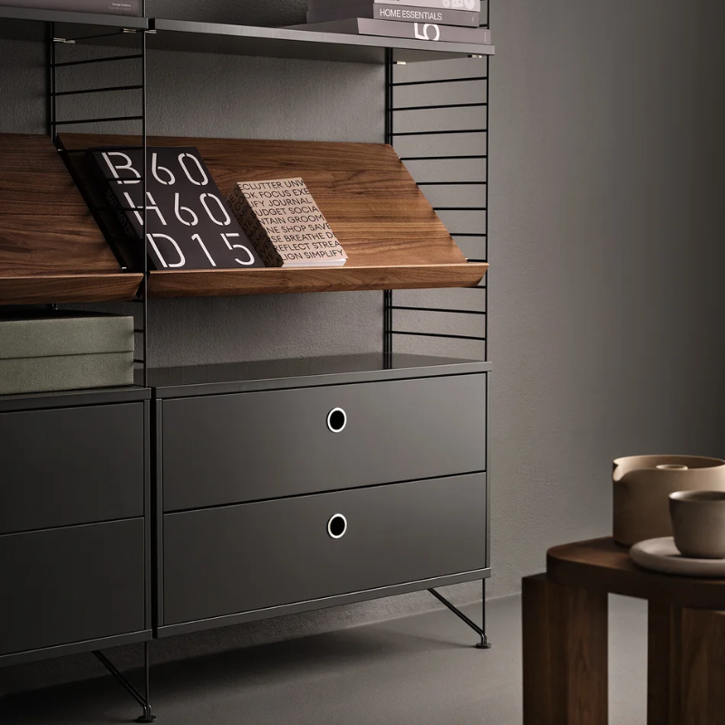 The Floor Panels from String Furniture in dark grey in a family room.