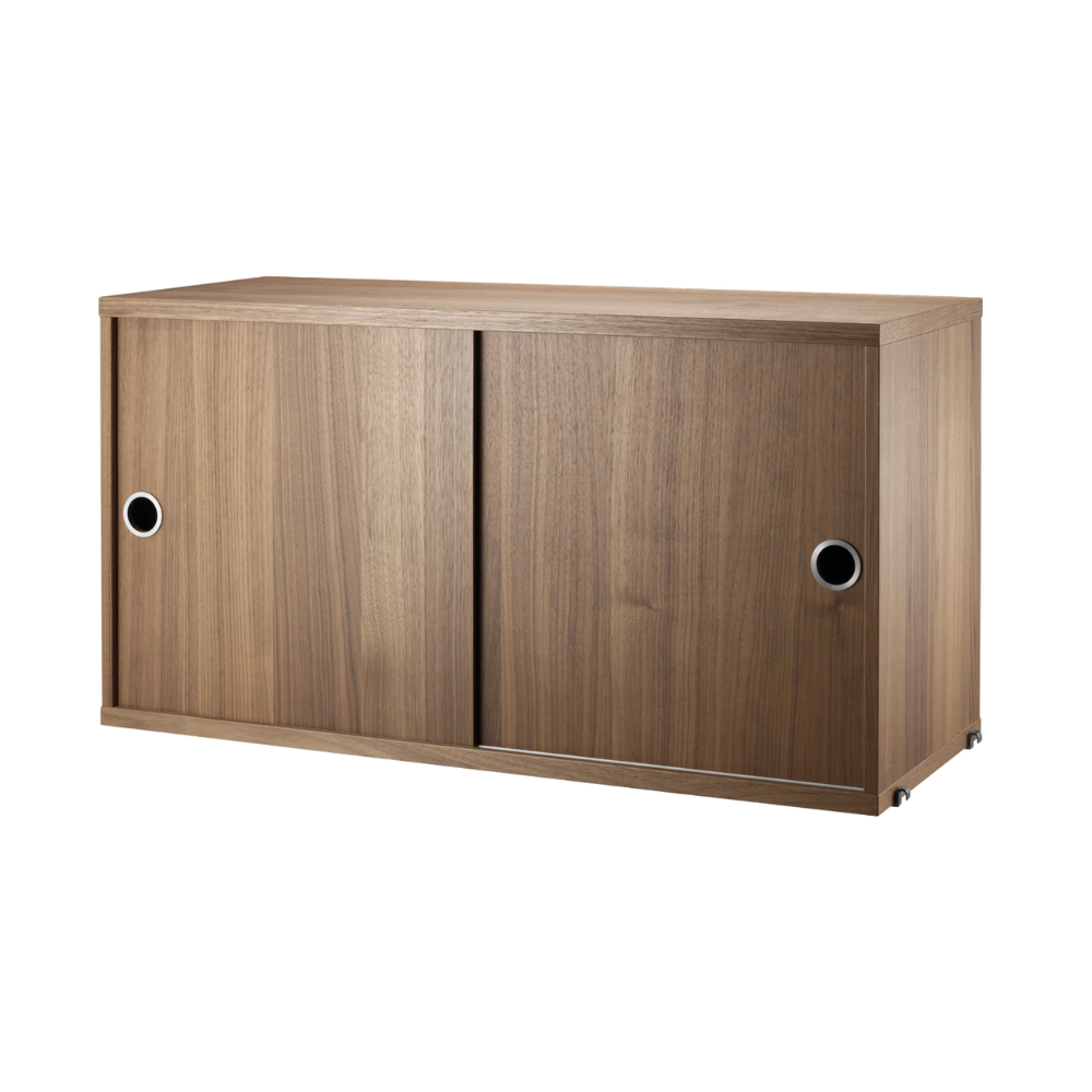 The Cabinet with Sliding Doors from String Furniture in the 11.8 inch depth size and walnut color.