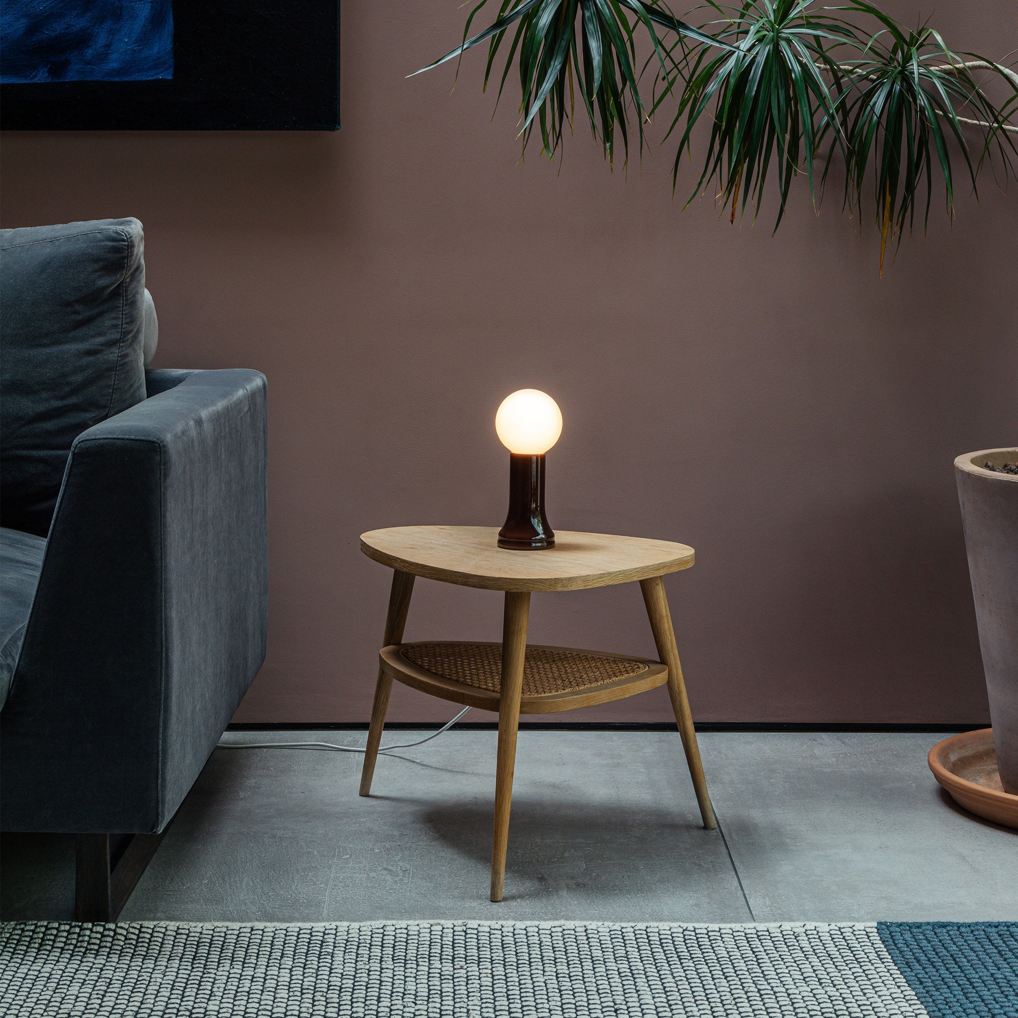 The Shore Table lamp from Tala Lighting in Brown on a side table in a living room.
