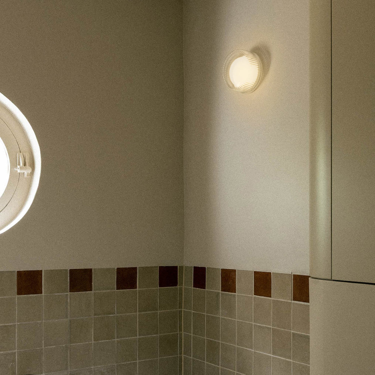 The Firth Wall Light by Tala Lighting in a bathroom.