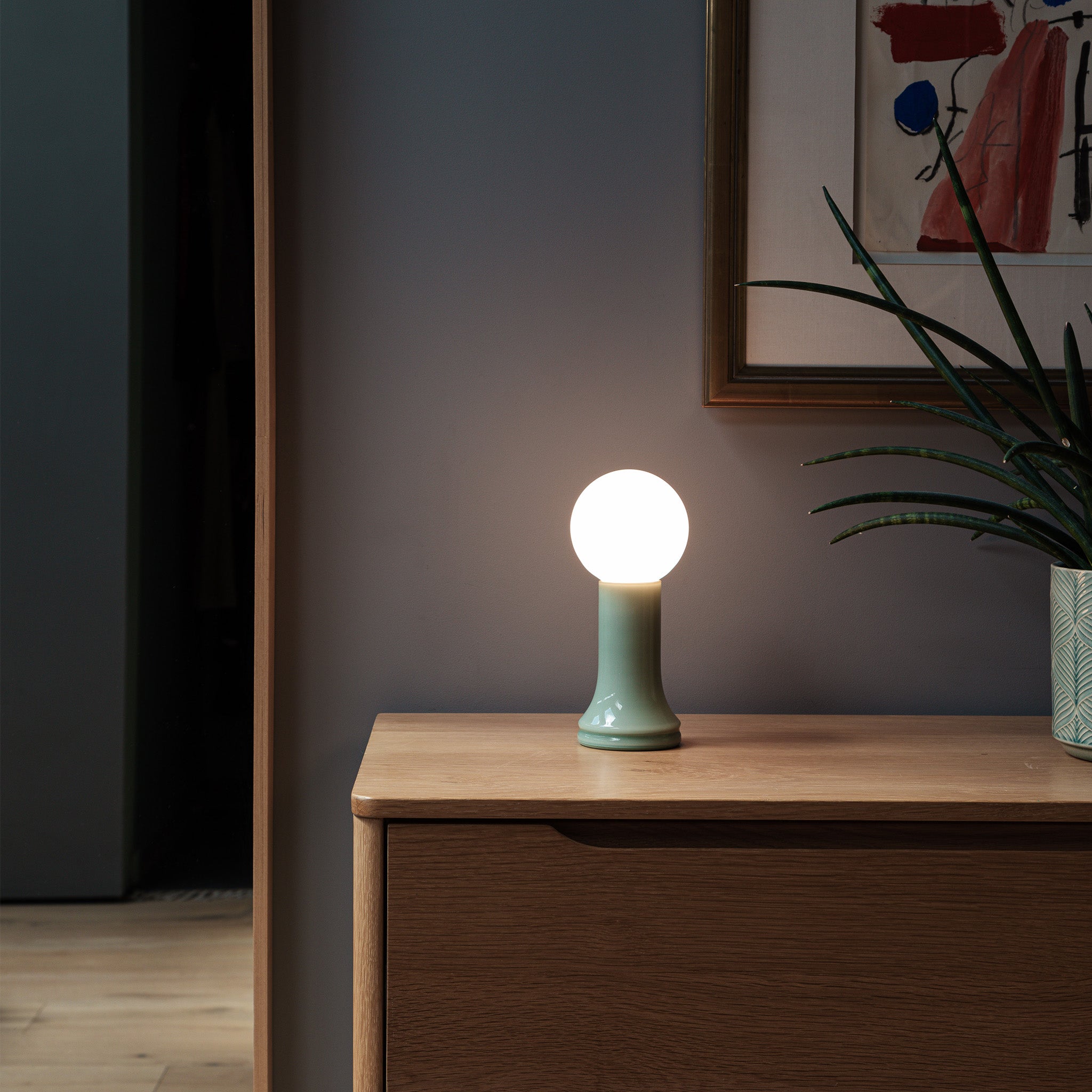 The Shore Table Lamp from Tala Lighting in Sea Green on a sideboard.