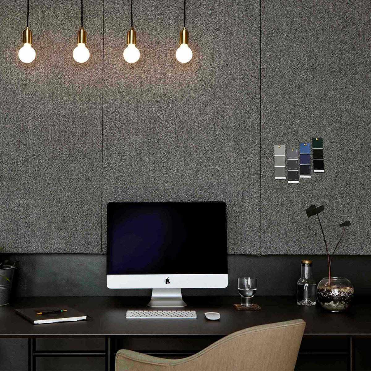 The Sphere II E26 Dim-to-Warm LED Bulb by Tala Lighting with brass pendant in an office.