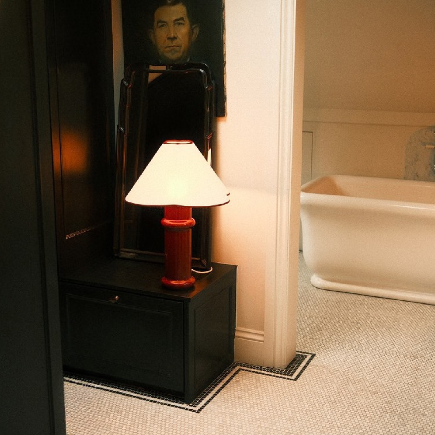 the Heath Table Lamp by Tala Lighting in Port Red in a hallway.