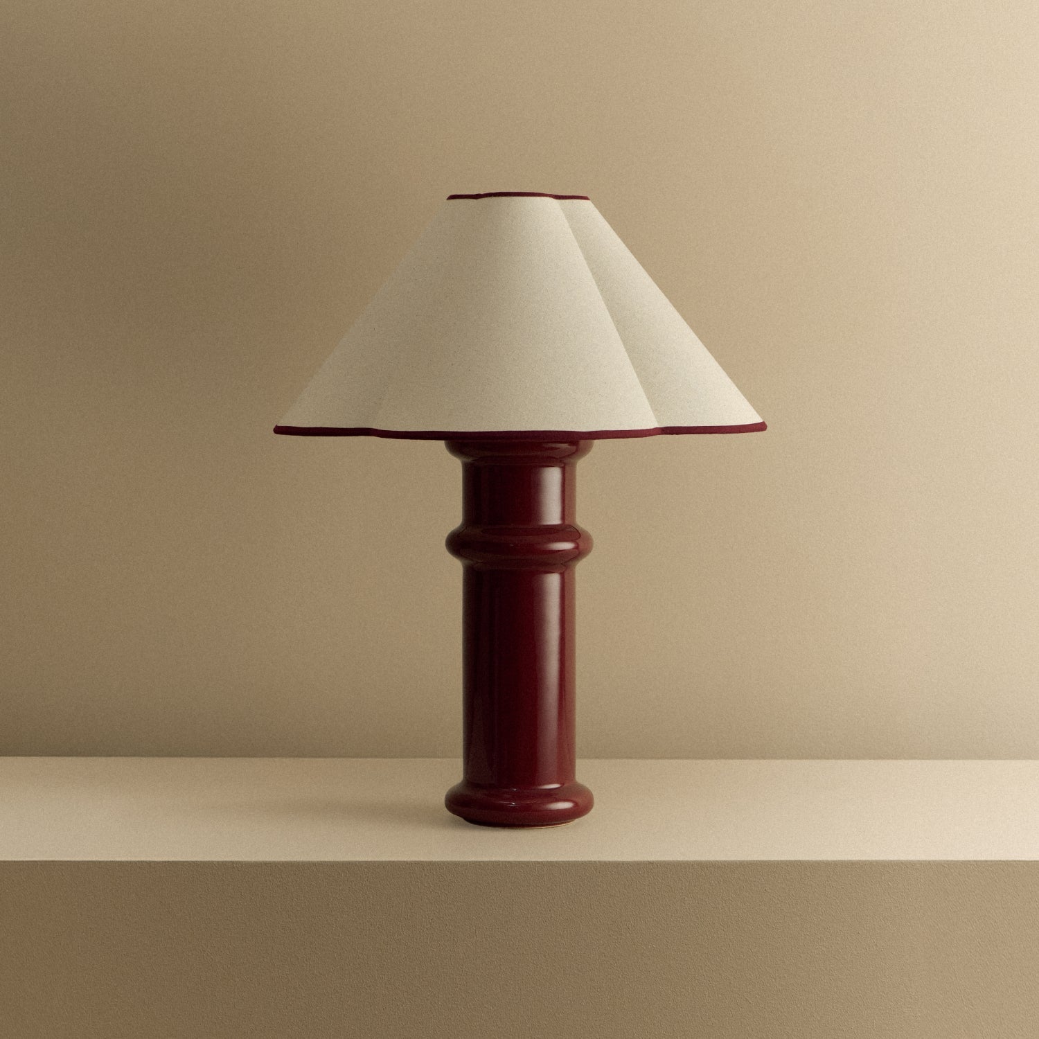 The Heath Table Lamp by Tala Lighting in Port Red turned off.