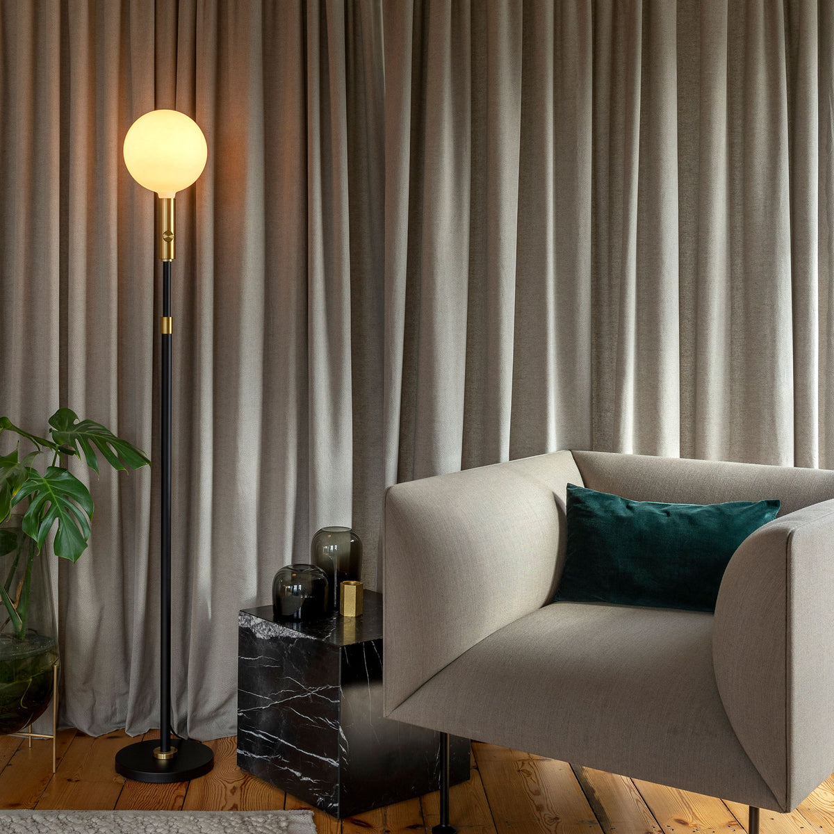 The Sphere V E26 Dim-to-Warm LED Bulb paired with a floor lamp base by Tala Lighting