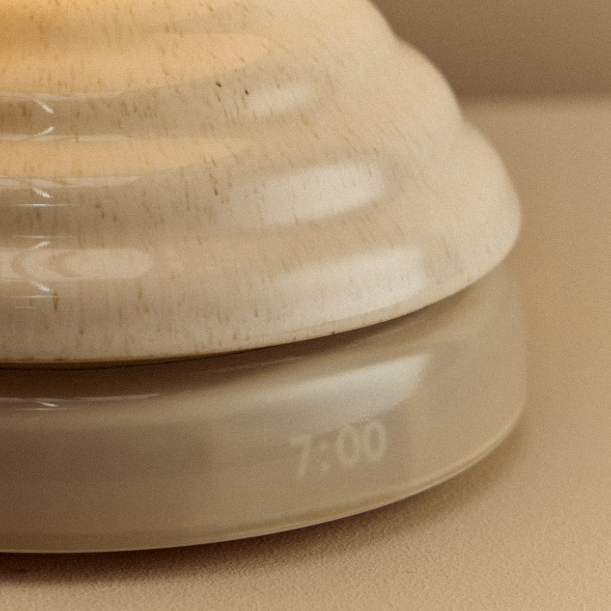 Detail of the pebble white ceramic base with integrated clock of the Wake Sleep Light by Tala Lighting.