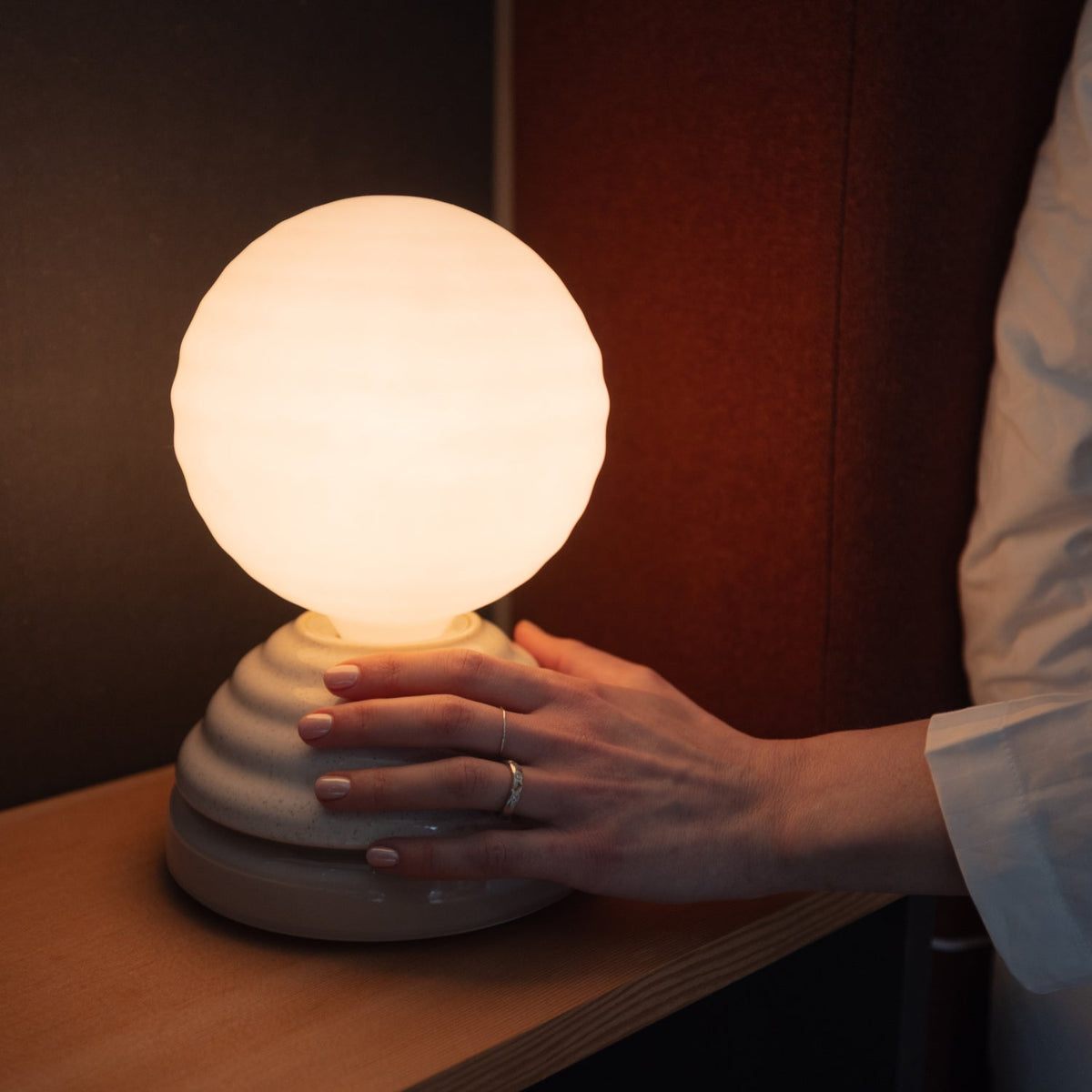 The Wake Sleep Light by Tala Lighting in pebble white being turned on.