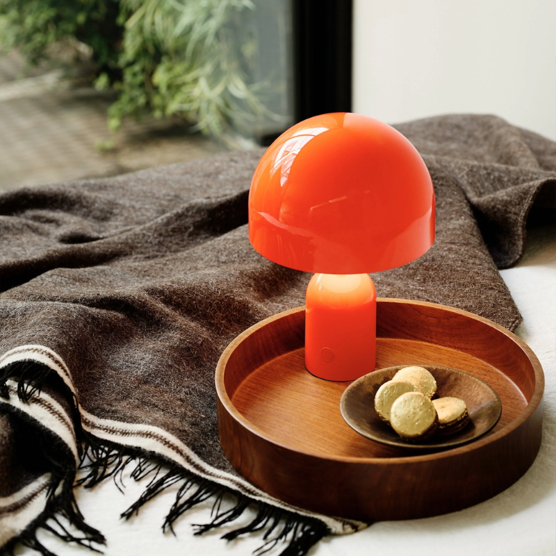 The Bell Portable LED from Tom Dixon in fluro in a primary bedroom.