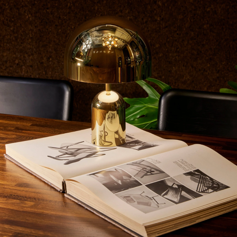 The Bell Portable LED from Tom Dixon in gold in a commercial office.