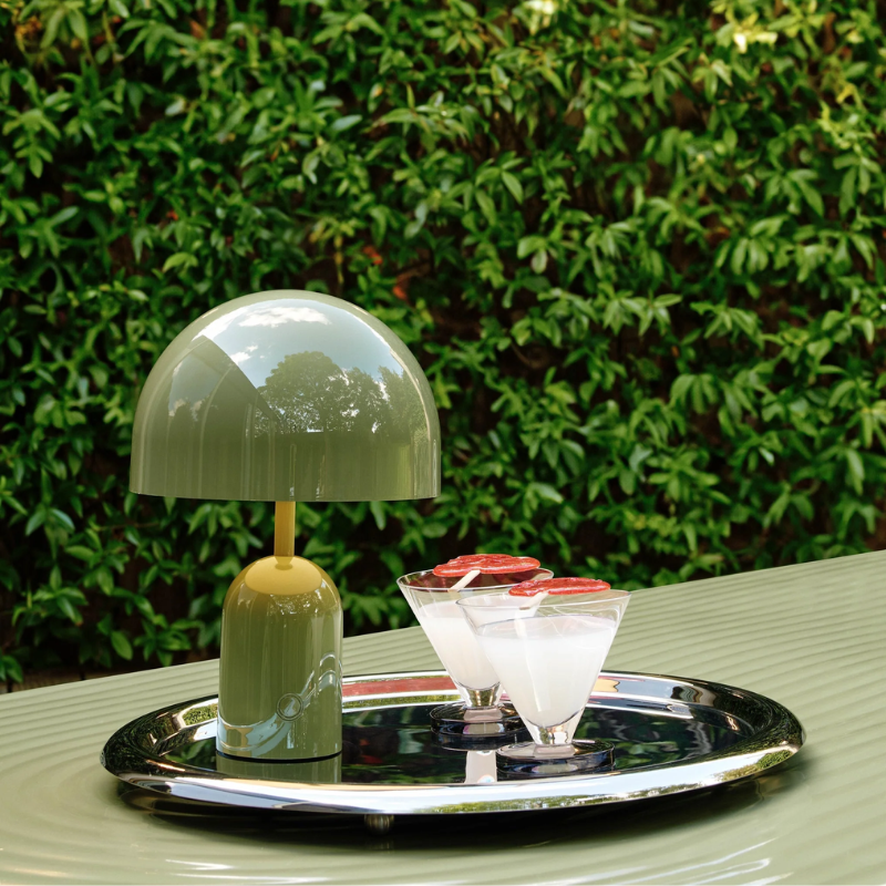 The Bell Portable LED from Tom Dixon in moss with cocktails.