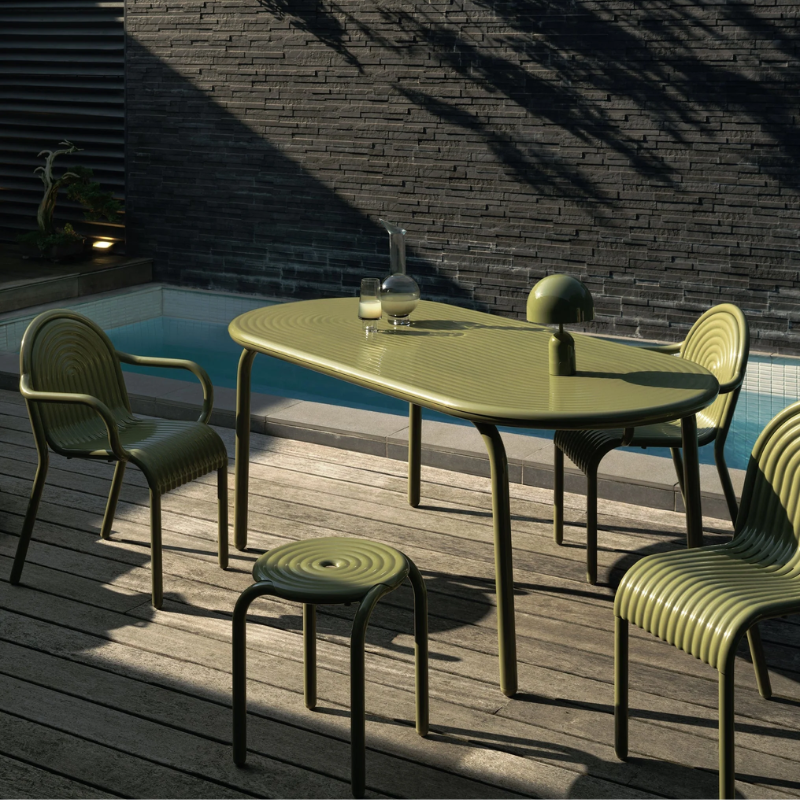 The Bell Portable LED from Tom Dixon in moss in an outdoor lounge.