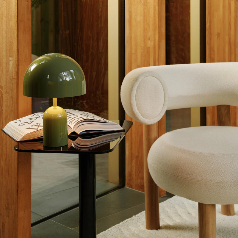 The Bell Portable LED from Tom Dixon in moss in a reading area.