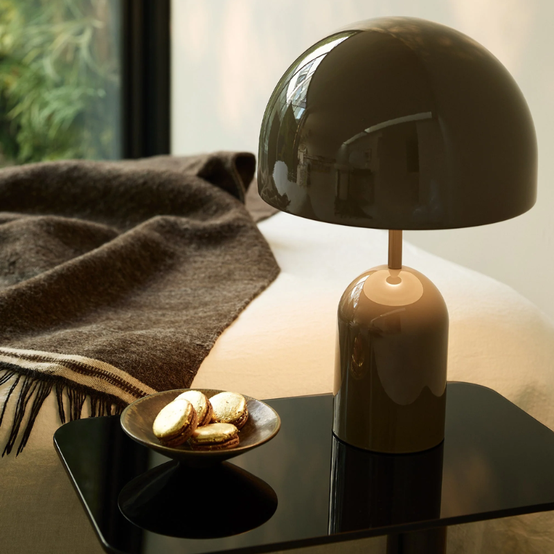 The Bell Portable LED from Tom Dixon in taupe in a bedroom.