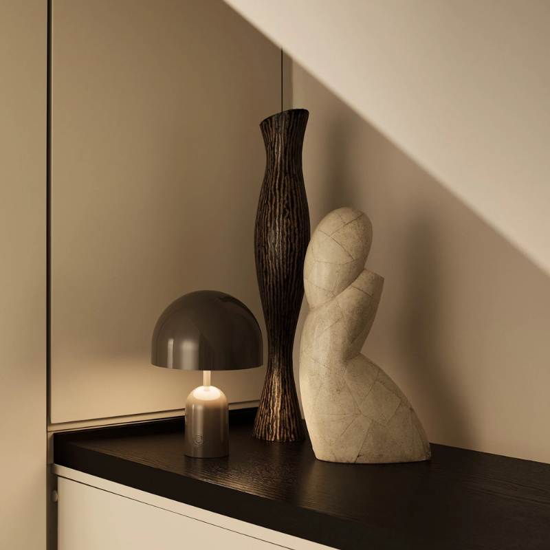 The Bell Portable LED from Tom Dixon in taupe in a library.