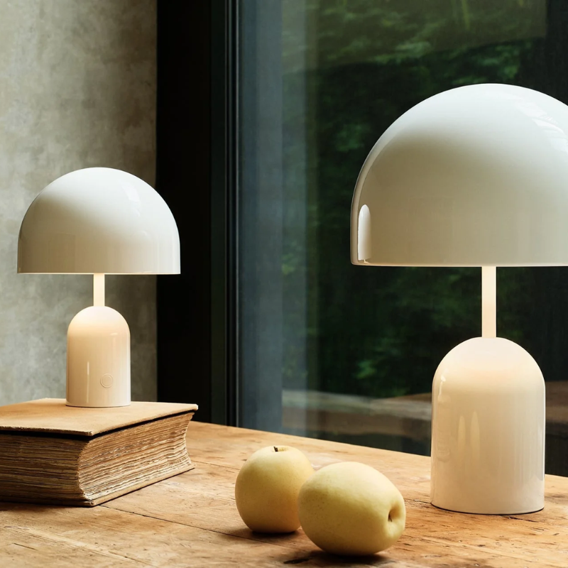 The Bell Portable LED from Tom Dixon in white on a desk.