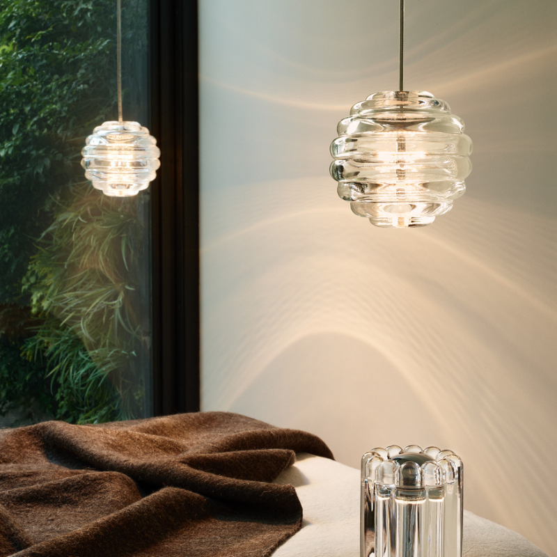 Tom Dixon Press Sphere Mini Pendants over a dining table.