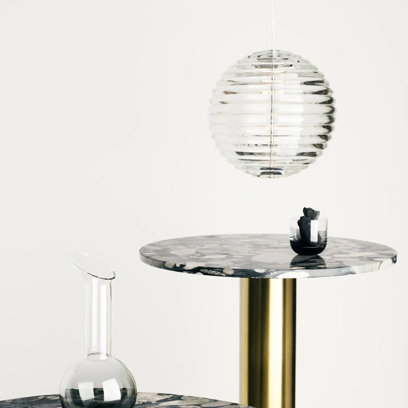 Tom Dixon Press Medium Sphere Pendant over a dining table.