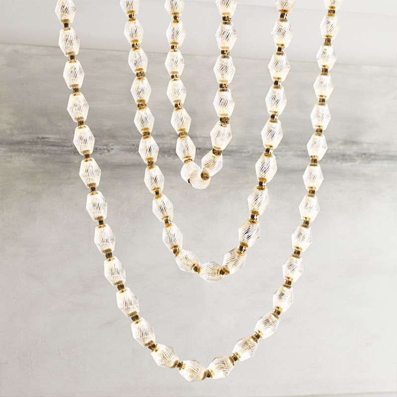 Close-up image of the Collier 108 Chandelier from Visual Comfort & Co in natural brass.