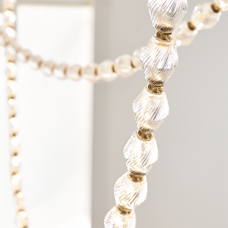 The Collier 108 Chandelier from Visual Comfort and Co in natural brass up close.