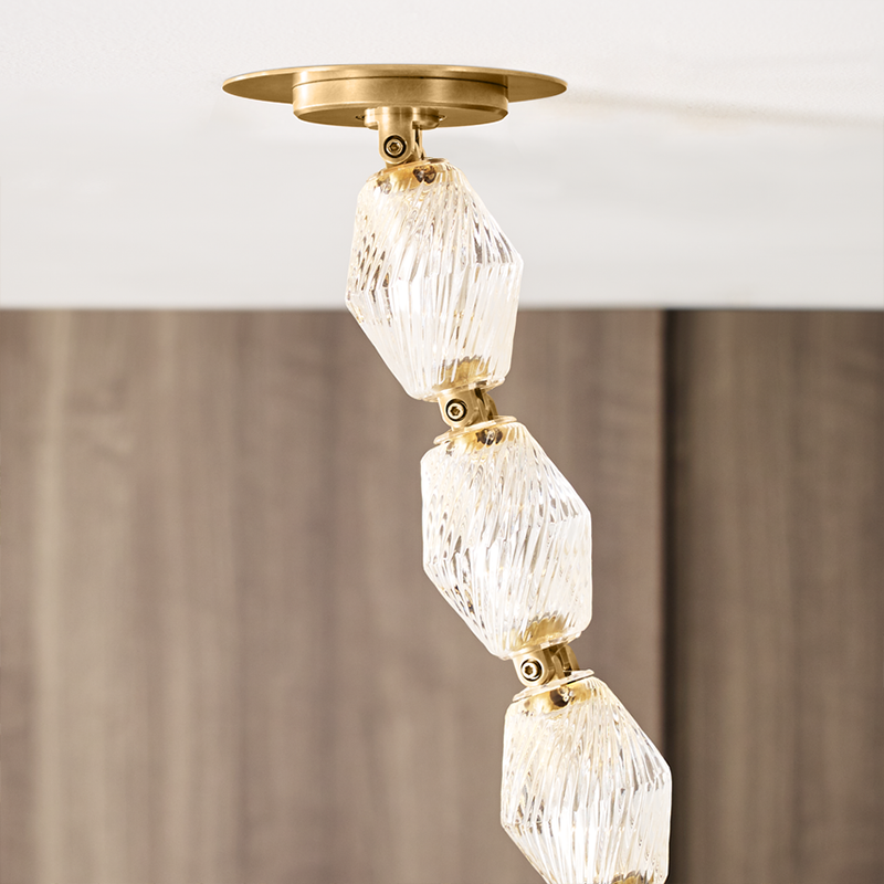The Collier 84 Chandelier from Visual Comfort and Co in natural brass in an office, focusing on the canopy.