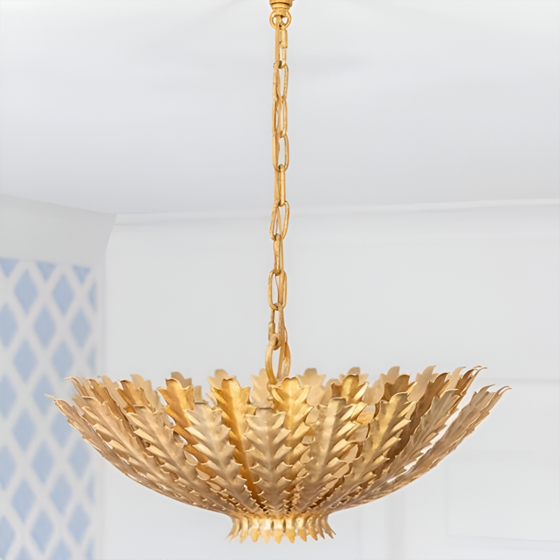 The Hampton Medium Chandelier from Visual Comfort and Co in antique gold in a dining room.