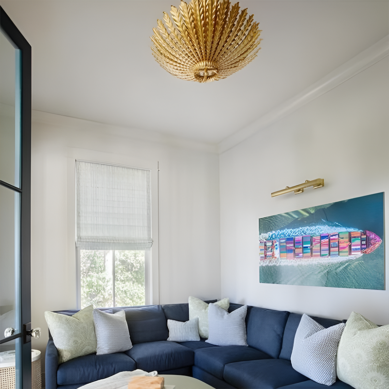 The Hampton Medium Chandelier from Visual Comfort and Co in antique gold in a lounge.