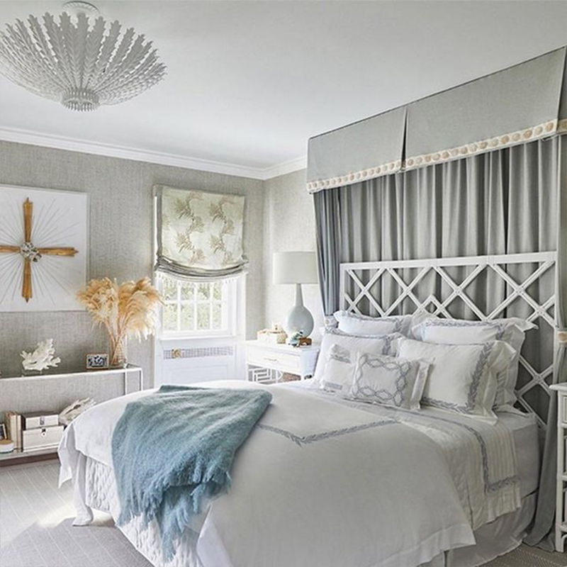 The Hampton Medium Chandelier from Visual Comfort and Co in plaster white in a guest bedroom.