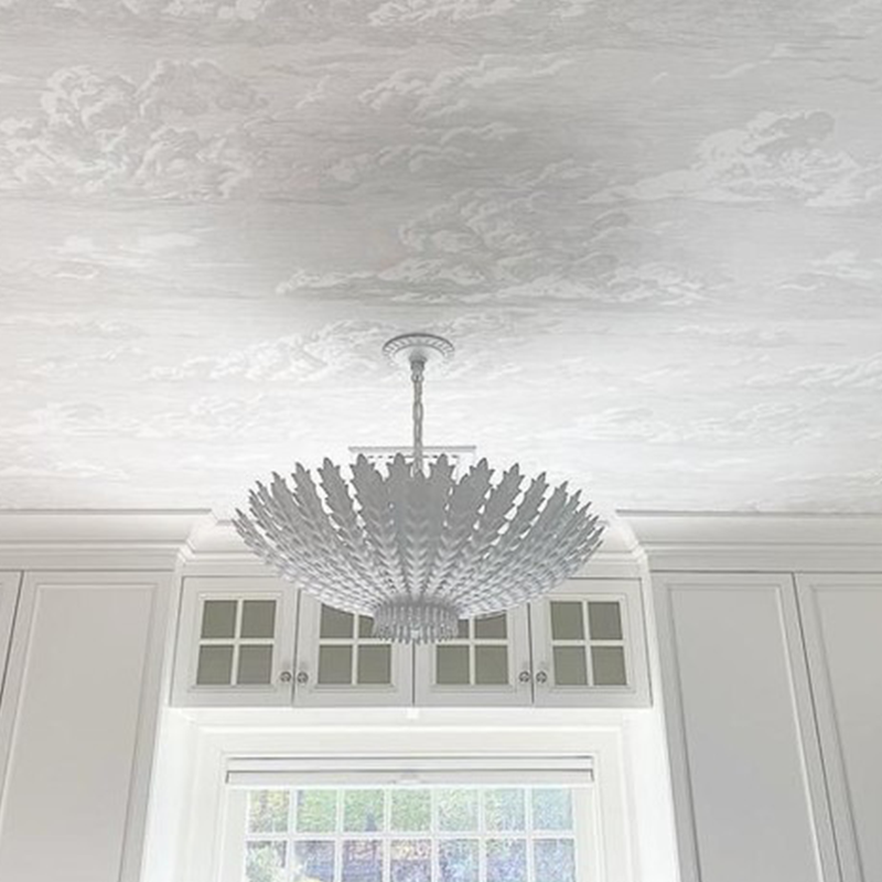 The Hampton Medium Chandelier from Visual Comfort and Co in plaster white in a restaurant.