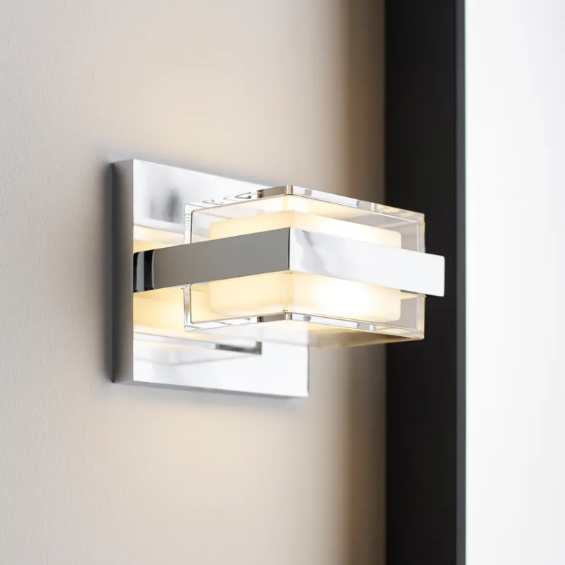 The Kamden 1-Light Bathroom Sconce from Visual Comfort & Co. in a washroom.