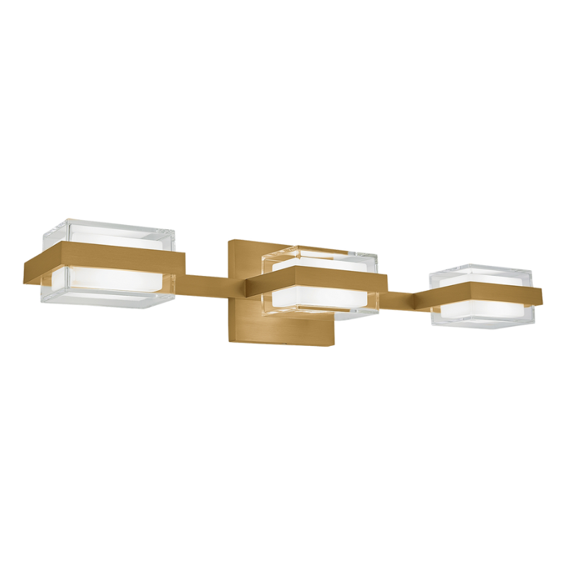 The Kamden 3-Light Bathroom Sconce from Visual Comfort & Co. in natural brass.
