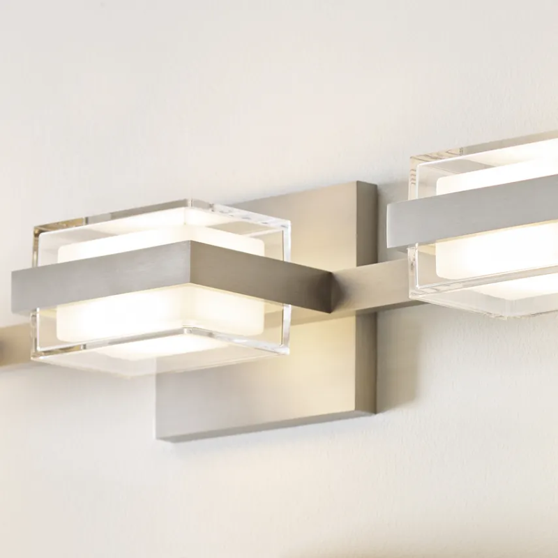 The Kamden 3-Light Bathroom Sconce from Visual Comfort & Co. close up.