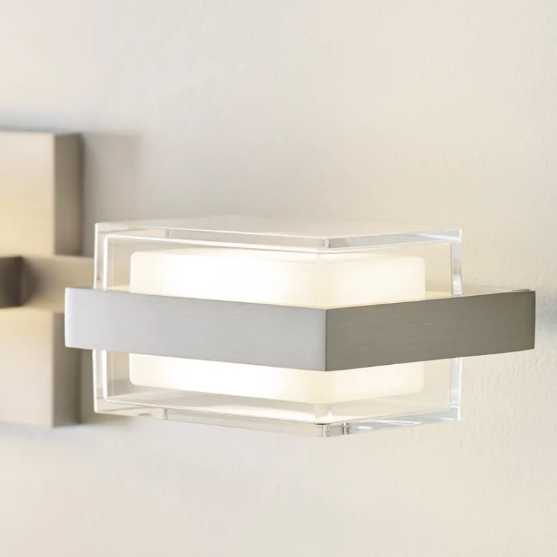 The Kamden 3-Light Bathroom Sconce from Visual Comfort & Co. in a washroom.
