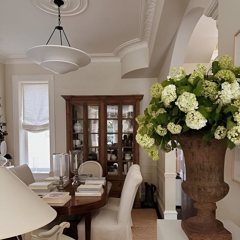 The Mollino Large Tiered Chandelier from Visual Comfort and Co in bronze in a formal dining room.