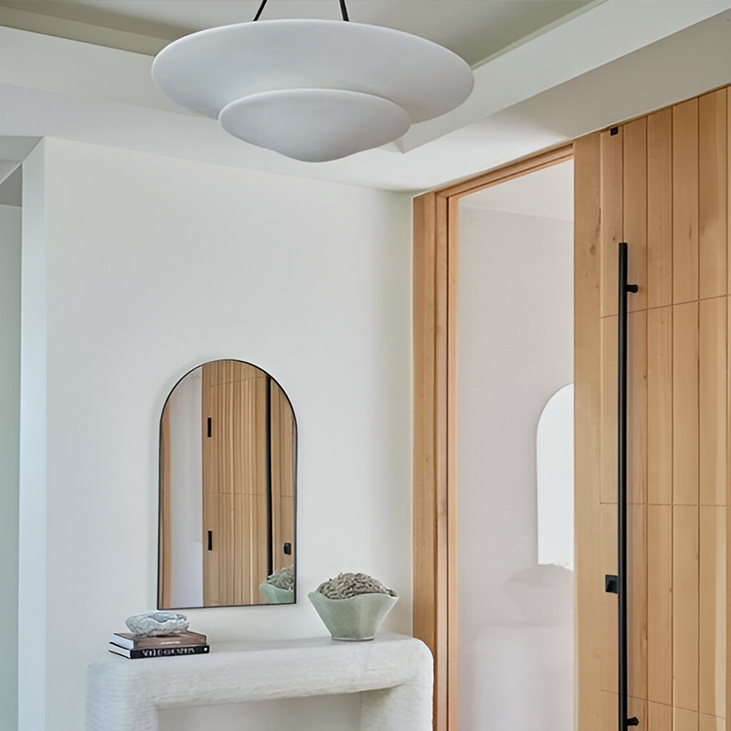 The Mollino Large Tiered Chandelier from Visual Comfort and Co in bronze in a guest bedroom.