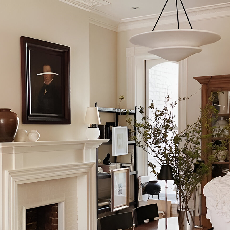 The Mollino Large Tiered Chandelier from Visual Comfort and Co in bronze in a dining room.