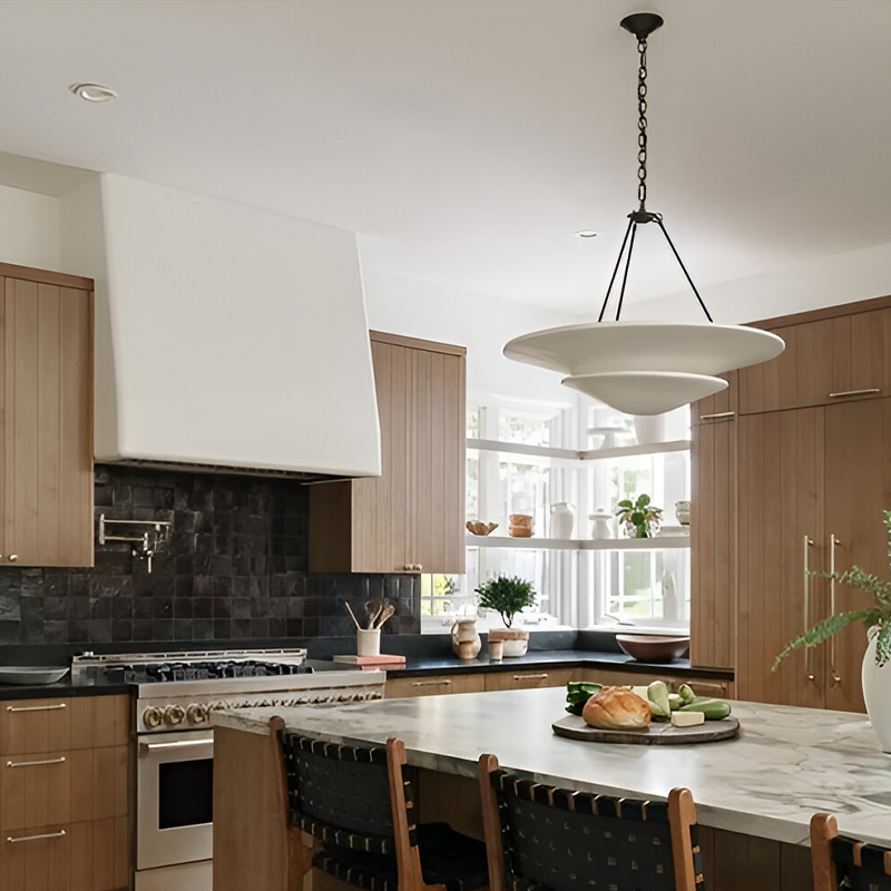The Mollino Large Tiered Chandelier from Visual Comfort and Co in bronze in a kitchen.