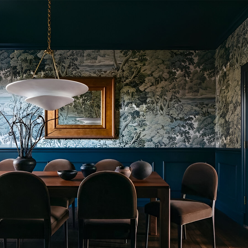 The Mollino Large Tiered Chandelier from Visual Comfort and Co in hand-rubbed antique brass in a dining room.