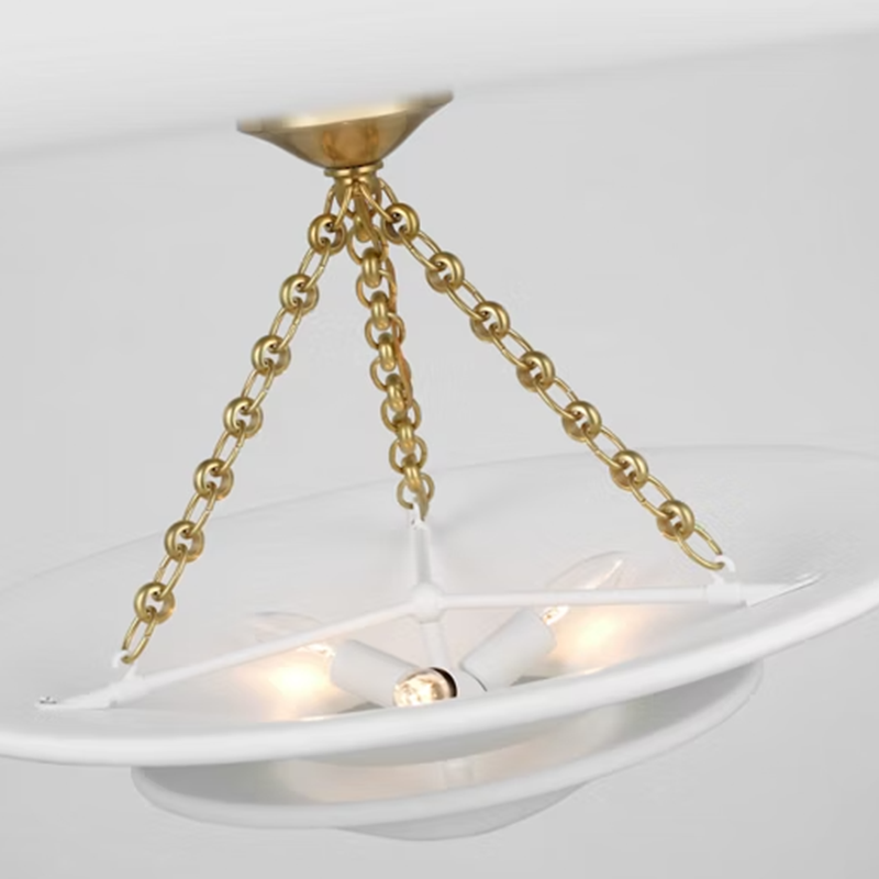 The Mollino Medium Tiered Chandelier from Visual Comfort and Co in hand-rubbed antique brass detailed view of brass hardware.