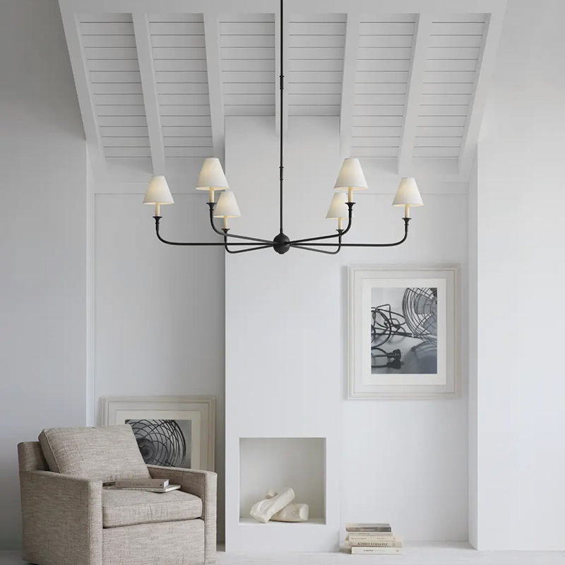 The Piaf Grande Chandelier from Visual Comfort & Co. in aged iron and ebonized oak in a family space.