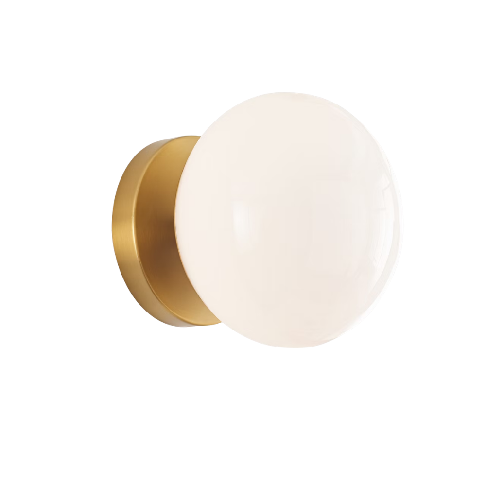 The Lune 1-Light Bath Sconce from Visual Comfort & Co in Burnished Brass turned on.