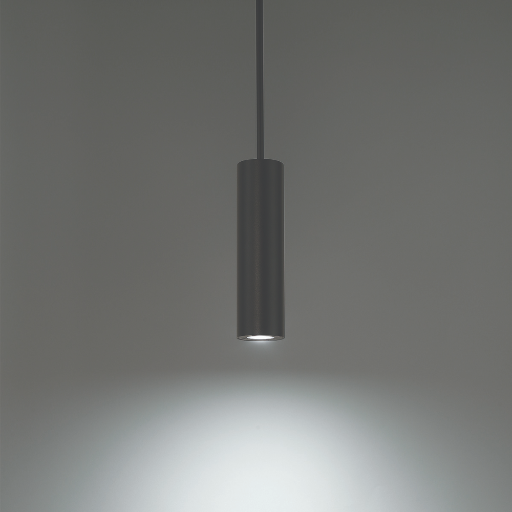 The black Caliber Mini Pendant from WAC Lighting in a studio.